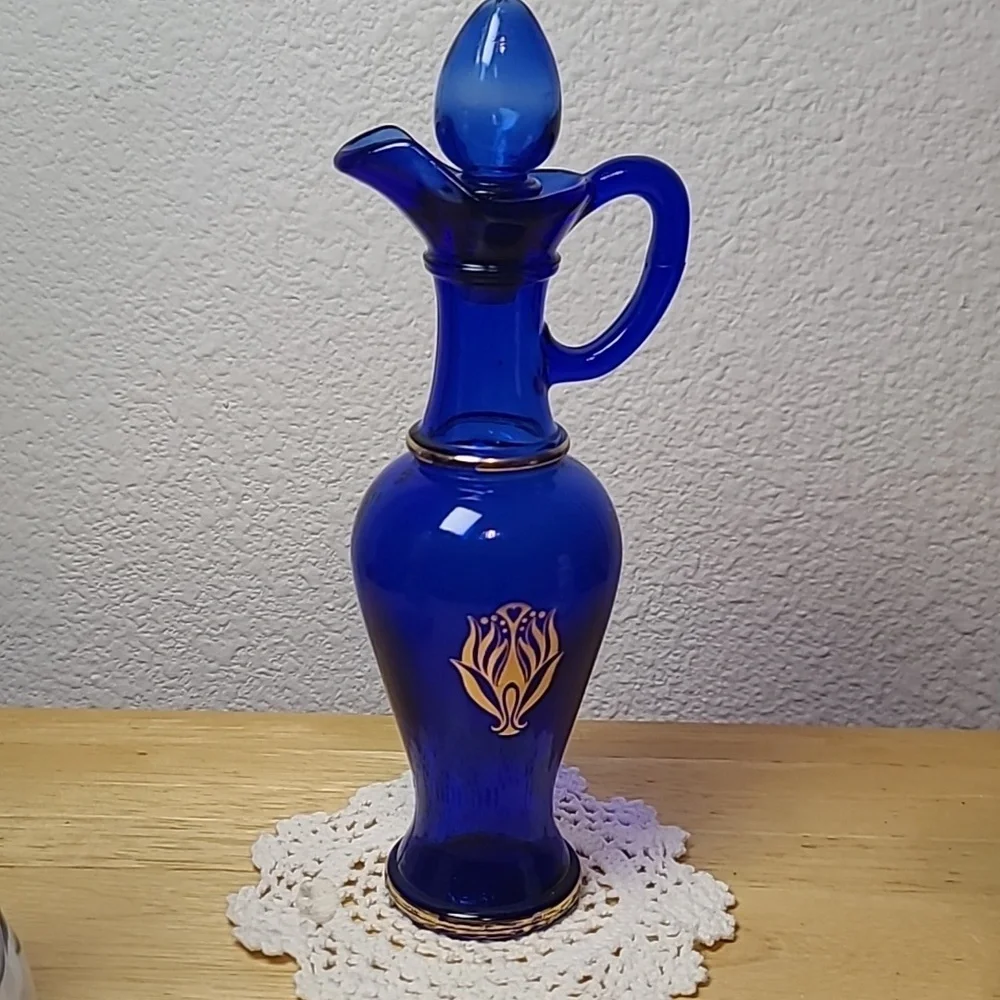Avon set of three milk glass and blue glass pitcher.